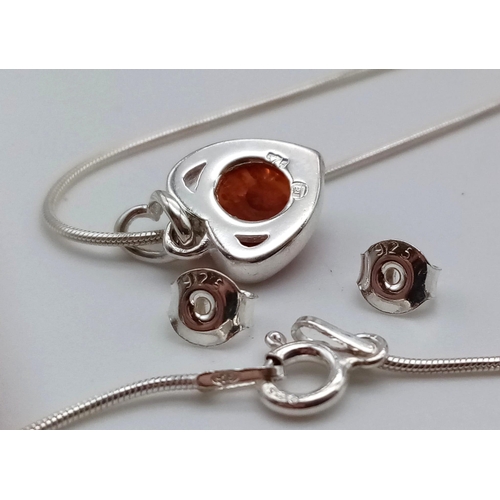 1085 - A Baltic Amber Jewellery Set. Silver disappearing necklace with a Baltic amber pendant plus a pair o... 