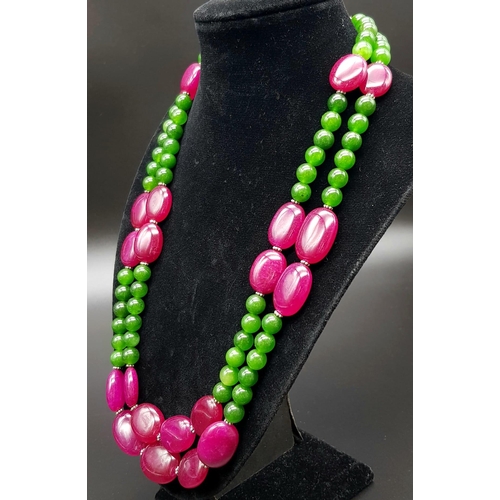 281 - A 650ct Jade and Ruby Bead Necklace. Circular jade beads with oval rubies. 8 and 20mm beads. 44-48cm... 