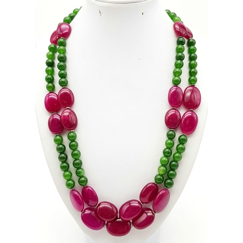 281 - A 650ct Jade and Ruby Bead Necklace. Circular jade beads with oval rubies. 8 and 20mm beads. 44-48cm... 