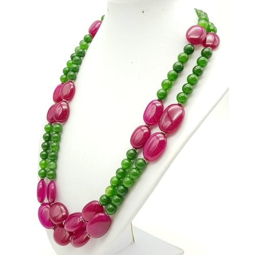 281 - A 650ct Jade and Ruby Bead Necklace. Circular jade beads with oval rubies. 8 and 20mm beads. 44-48cm... 