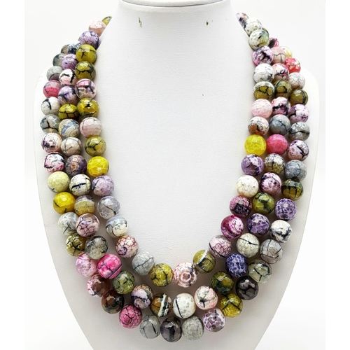 143 - An Exotic Three-Row 1400ct Dragons Vein Multi-Coloured Agate Bead Necklace. 12mm Beads.
40-48cm.