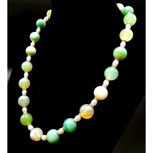 334 - A Freshwater Seed Pearl and Shades of Green Agate Necklace. 12mm agate beads. 925 silver clasp. 44cm