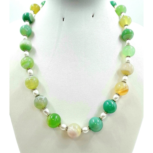 334 - A Freshwater Seed Pearl and Shades of Green Agate Necklace. 12mm agate beads. 925 silver clasp. 44cm