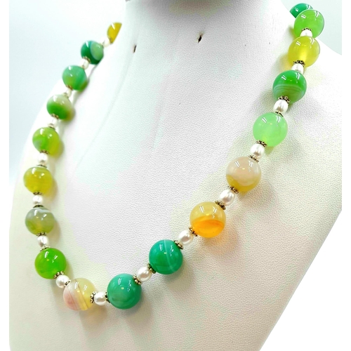 334 - A Freshwater Seed Pearl and Shades of Green Agate Necklace. 12mm agate beads. 925 silver clasp. 44cm