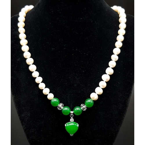 358 - A Freshwater Pearl and Green Jade Necklace. 7mm pearls. 8mm jade and a 15mm jade heart. 48cm.