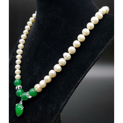 358 - A Freshwater Pearl and Green Jade Necklace. 7mm pearls. 8mm jade and a 15mm jade heart. 48cm.