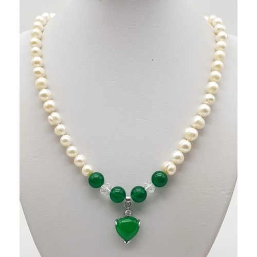 358 - A Freshwater Pearl and Green Jade Necklace. 7mm pearls. 8mm jade and a 15mm jade heart. 48cm.