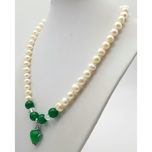 358 - A Freshwater Pearl and Green Jade Necklace. 7mm pearls. 8mm jade and a 15mm jade heart. 48cm.