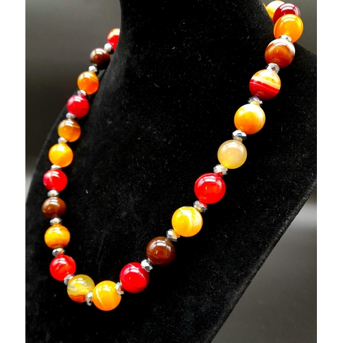 440 - An Autumn-Fire Agate Bead Necklace. 925 silver clasp.
12mm beads. 44cm.