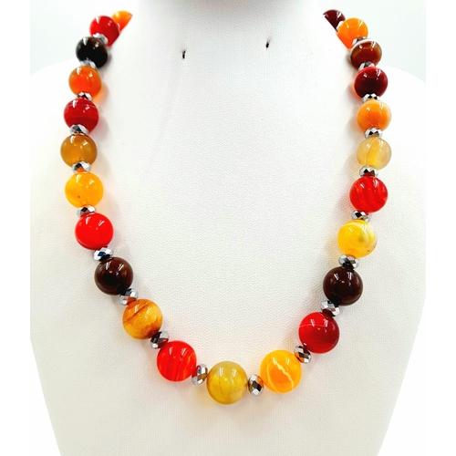 440 - An Autumn-Fire Agate Bead Necklace. 925 silver clasp.
12mm beads. 44cm.