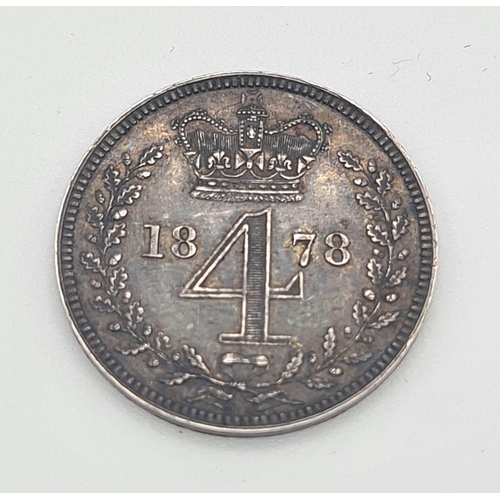 313 - An 1878 Silver Four Pence Coin. Near Uncirculated. Obverse - Bare head of Queen Victoria facing left... 