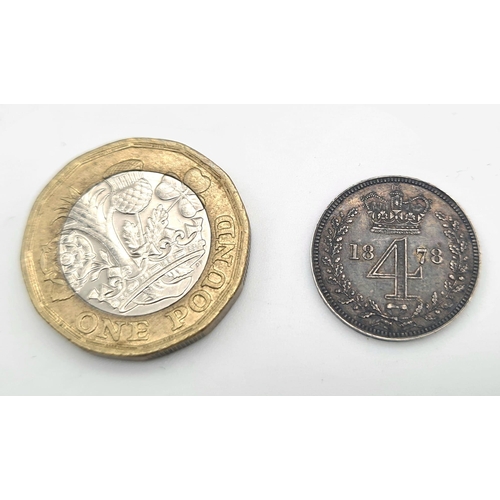 313 - An 1878 Silver Four Pence Coin. Near Uncirculated. Obverse - Bare head of Queen Victoria facing left... 