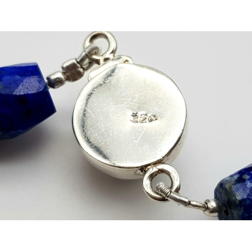 634 - A 495ct Fancy Lapis Lazuli Drum Shape bead necklace with a Pearl clasp in 925 silver. 44cm.