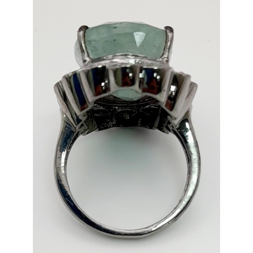 765 - A 17ct Oval Emerald Gemstone Ring with .22ct Diamonds set in pave setting. 925 silver. Size N.