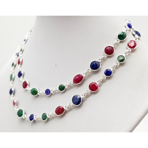 495 - A Ruby, Emerald and Sapphire Gemstone Long chain necklace set in 925 Silver. 22g total weight. 64cm