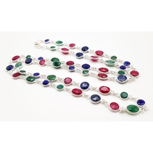 495 - A Ruby, Emerald and Sapphire Gemstone Long chain necklace set in 925 Silver. 22g total weight. 64cm