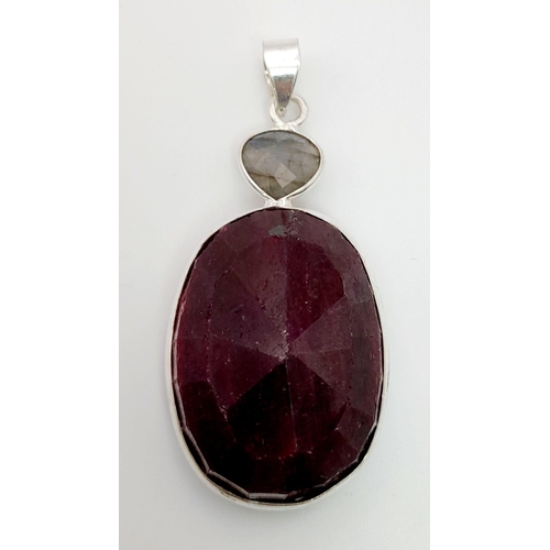 718 - A 285ct Oval Shape Ruby Gemstone Pendant set in 925 Silver. 5cm. Comes with a disappearing silver ne... 