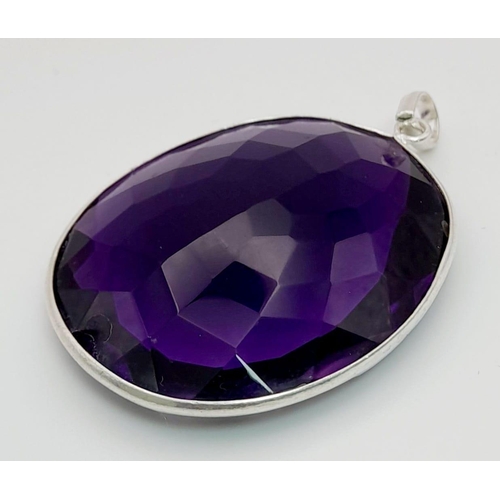 871 - A 105ct Hydro Amethyst Gemstone Pendant in a bezel setting, 925 silver. 40mm x 37mm. Comes with a di... 