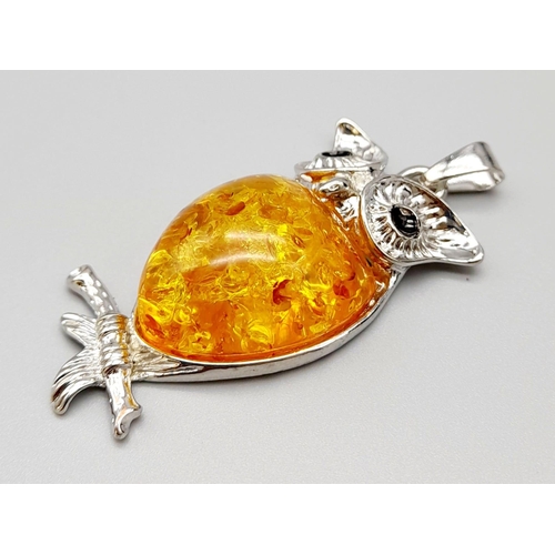 1083 - An Amber-Coloured Resin Owl Pendant.