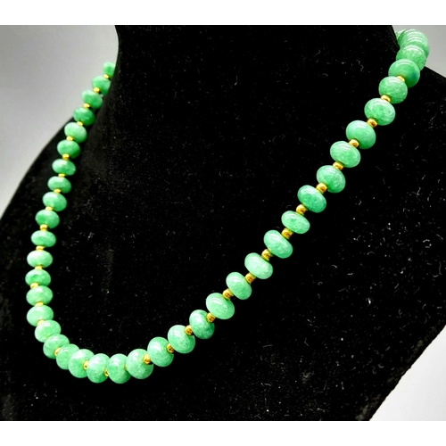 1104 - An Emerald Bead Necklace with Gilded Spacers and Clasp. 44cm.