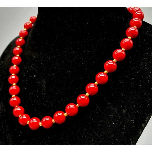 1139 - A Red Coral Beaded Necklace with Gilded Spacers and Clasp. 44cm