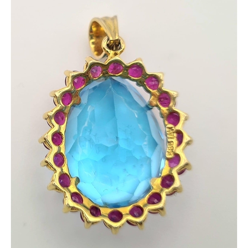 200 - A 14K Yellow Gold Large Topaz and Ruby Pendant. 7.93g total weight. Large bright topaz surrounded by... 