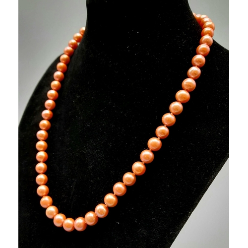 741 - A Pink-Orange Freshwater Pearl Necklace with 14K Yellow Gold Clasp. 44cm