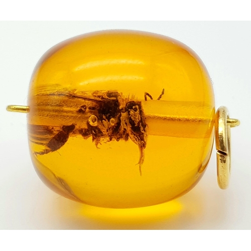 936 - A Bee Set in an Amber-Coloured Resin Pendant. 2.5cm