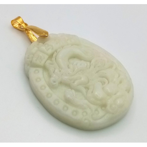 862 - A Carved Dragon Design White Jade Pendant - gilded attachment. 4.5cm