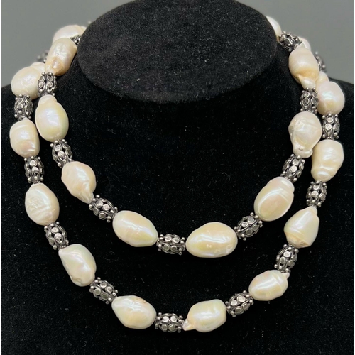 906 - A Vintage Baroque Pearl Necklace with Geometric Patterned Barrel Spacers. 68cm. 100g total weight.