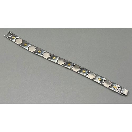 963 - A Stainless Steel Bracelet with 18K Yellow Gold Small Studs. 20cm. 44.72g total weight.