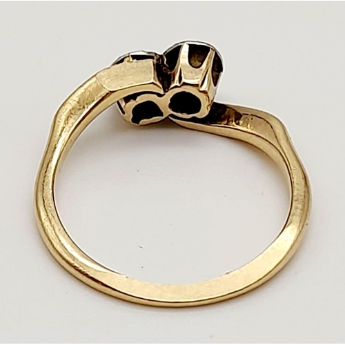 698 - A 9K Yellow Gold Two Diamond Crossover Ring. Size M.
2.39g total weight.