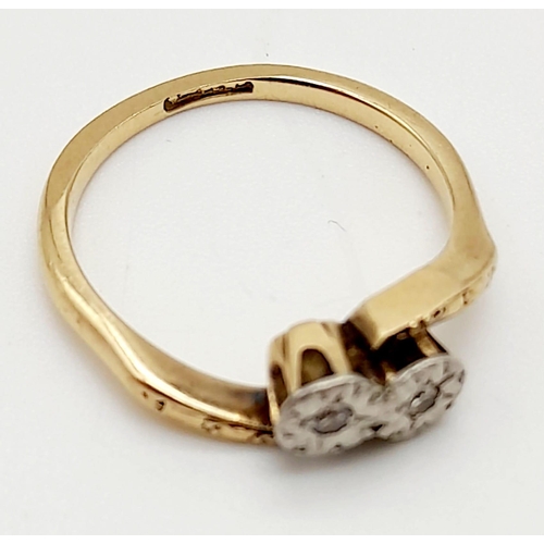 698 - A 9K Yellow Gold Two Diamond Crossover Ring. Size M.
2.39g total weight.