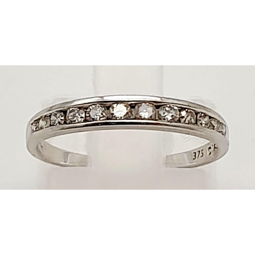 919 - A 9K White Gold Diamond Half Eternity Ring. Size J.
1.12g total weight.