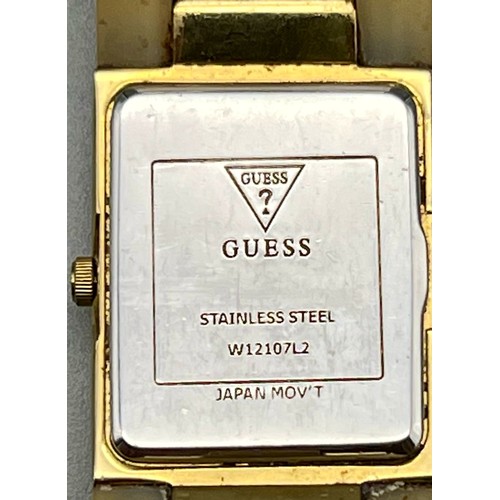 492 - A Guess Ladies Gilt and Ceramic Quartz Dress Watch. In working order.