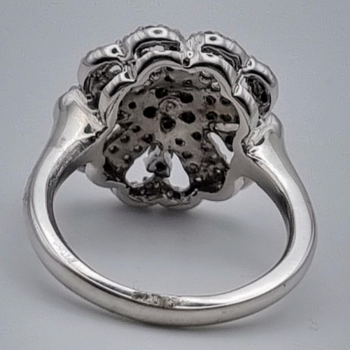 898 - 10K WHITE GOLD DIAMOND SET FLOWER CLUSTER RING. SIZE N. 0.45CT. 6G.