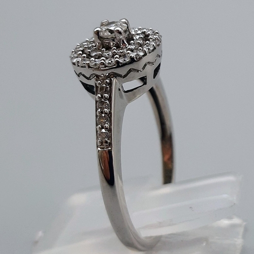 802 - 9K WHITE GOLD DIAMOND CLUSTER HALO RING. 0.50CT. SIZE Q. 3.4G.