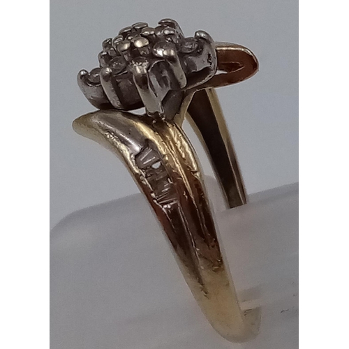 939 - A 10K GOLD DIAMOND SET TWIST CLUSTER RING. .20ct DIAMONDS . 2.2gms  size L