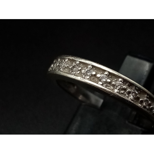 969 - A 9K White Gold Diamond Half Eternity Ring. 0.10ct. 
Size O. 2g