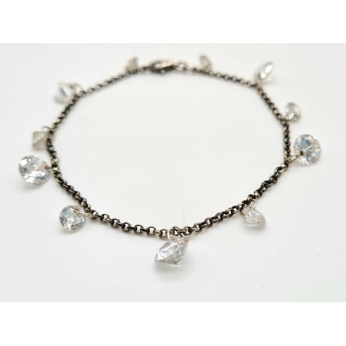 617 - A SILVER CRYSTAL CHARM BRACELET.   5.2gms