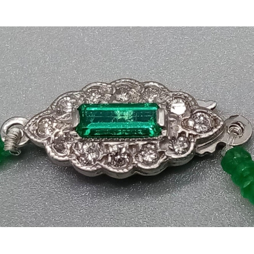 338 - A Natural Emerald and Diamond Necklace. Small emerald beads with an emerald and 12 diamond clasp on ... 