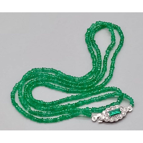 338 - A Natural Emerald and Diamond Necklace. Small emerald beads with an emerald and 12 diamond clasp on ... 