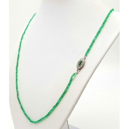 338 - A Natural Emerald and Diamond Necklace. Small emerald beads with an emerald and 12 diamond clasp on ... 