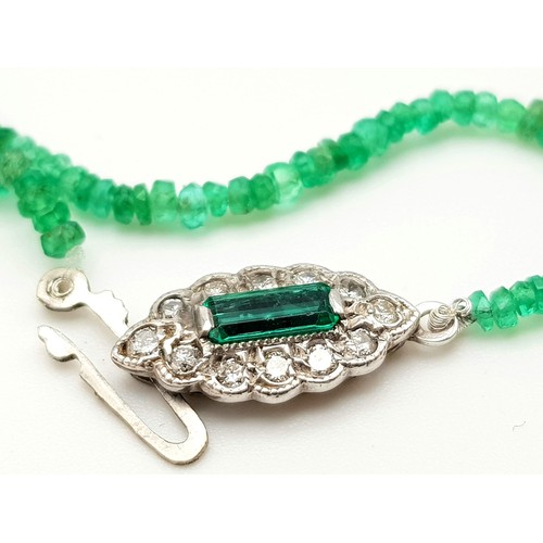 338 - A Natural Emerald and Diamond Necklace. Small emerald beads with an emerald and 12 diamond clasp on ... 