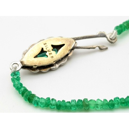 338 - A Natural Emerald and Diamond Necklace. Small emerald beads with an emerald and 12 diamond clasp on ... 