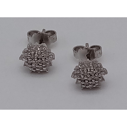 455 - A Pair of 18K White Gold Diamond Cluster Stud Earrings.
3.21g