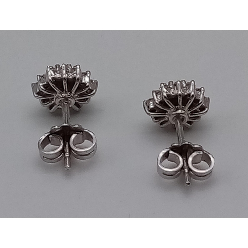 455 - A Pair of 18K White Gold Diamond Cluster Stud Earrings.
3.21g