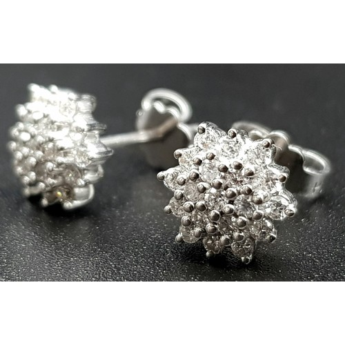 455 - A Pair of 18K White Gold Diamond Cluster Stud Earrings.
3.21g