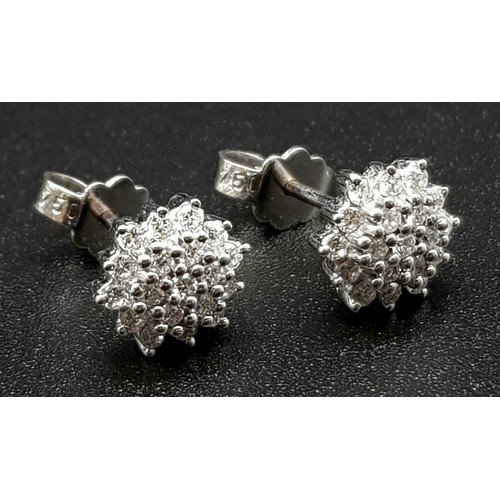 455 - A Pair of 18K White Gold Diamond Cluster Stud Earrings.
3.21g