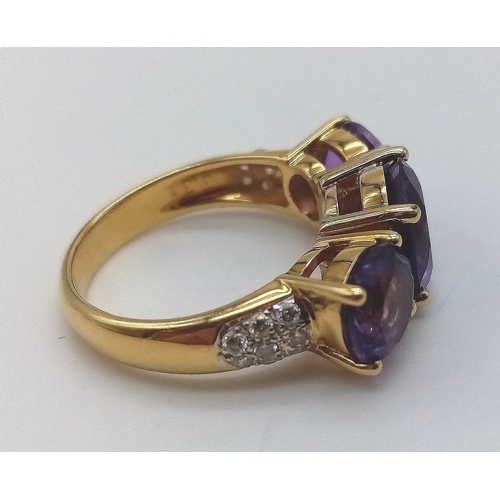 469 - An 18K Yellow Gold and Large Three-Stone Amethyst and Diamond Ring. Three central intense clean amet... 